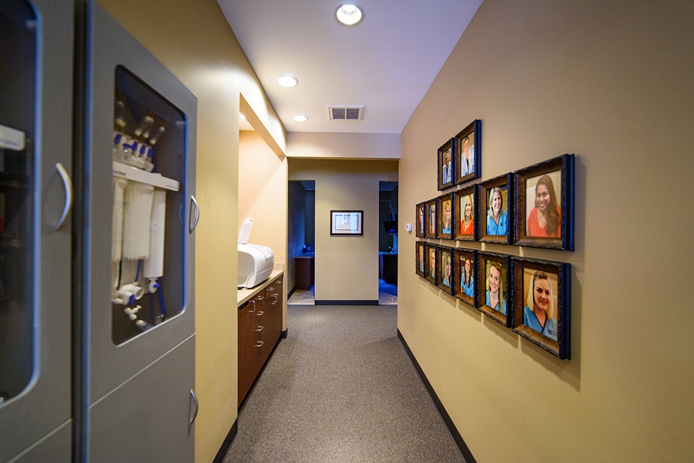A hallway adorned with pictures of our dedicated dental team at our Copperas Cove dental office.